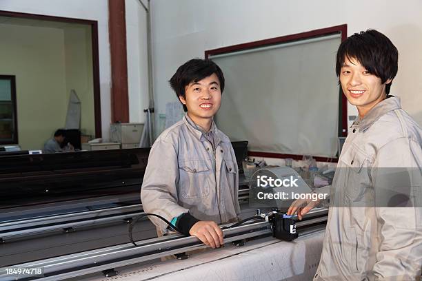 East Asian Workers Operating The Printer Stock Photo - Download Image Now - Factory, Smiling, 20-29 Years