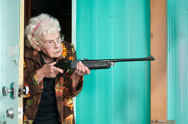 istock Elderly woman protecting her trailor with a BB gun 184975066