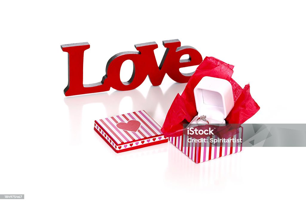 Diamond Ring in Box with the Word LOVE "A diamond ring in a decorative gift box with the word LOVE, on white. Selective focus is on the diamond." Box - Container Stock Photo