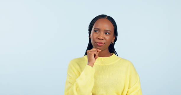 istock Woman, ideas and thinking in studio while planning choice, future inspiration and mockup space on blue background. African model daydream of decision, remember memory or solution of questions in mind 1849754752