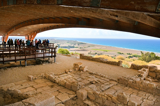 Episkopi,Cyprus - September 30, 2023: Group of tourists visits the ancient mosaics and excavations located under a special roof structure in Kourion archaeological park, situated on Akrotiri peninsula - a part of the British Overseas Territory of Akrotiri