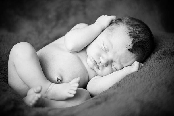 istock Peaceful Newborn Baby Lying on Side, in Black and White 184975842