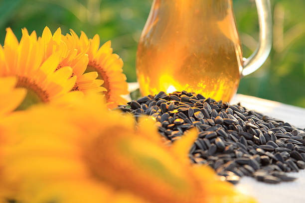 istock Oil bottle with sunflowers 184976054