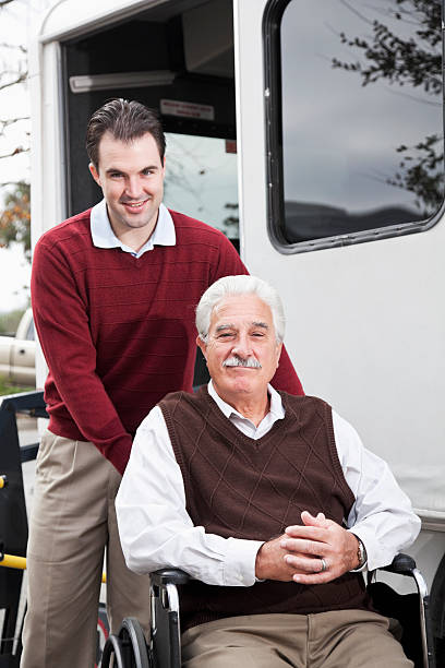 istock Senior man by minibus with wheelchair lift 184976185