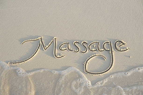 Massage Message Handwritten in Smooth Sand stock photo