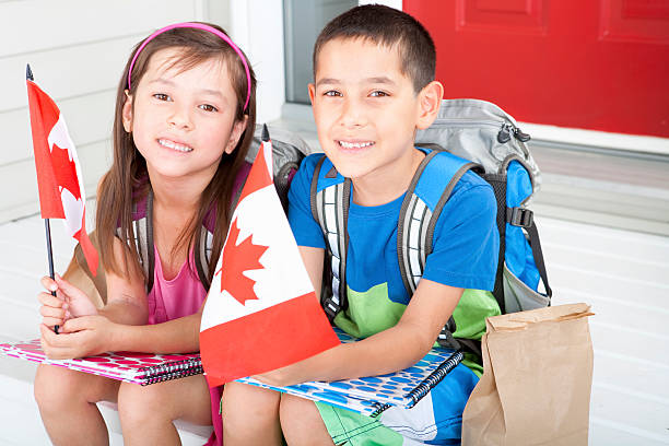 istock Siblings student holding canadian flag 184976518