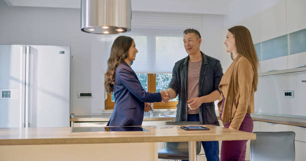istock Real estate agent shaking hands with clients 1849766781