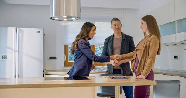 istock Real estate agent shaking hands with clients 1849766800