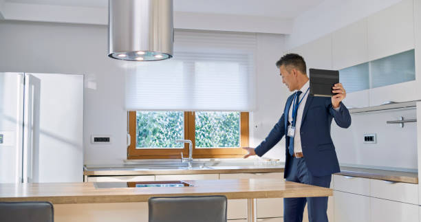 istock Real estate agent showing luxury house on digital tablet 1849767050