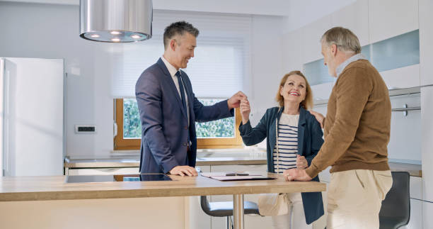 istock Real estate agent giving keys to clients 1849767079