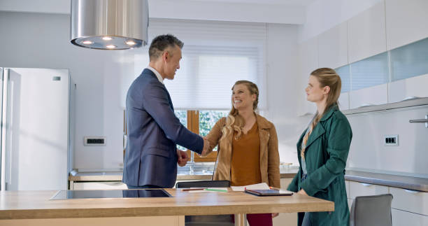 istock Real estate agent shaking hands with lesbian couple 1849767181