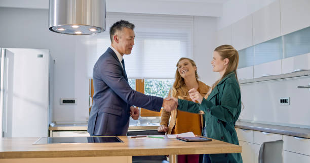 istock Real estate agent shaking hands with lesbian couple 1849767197