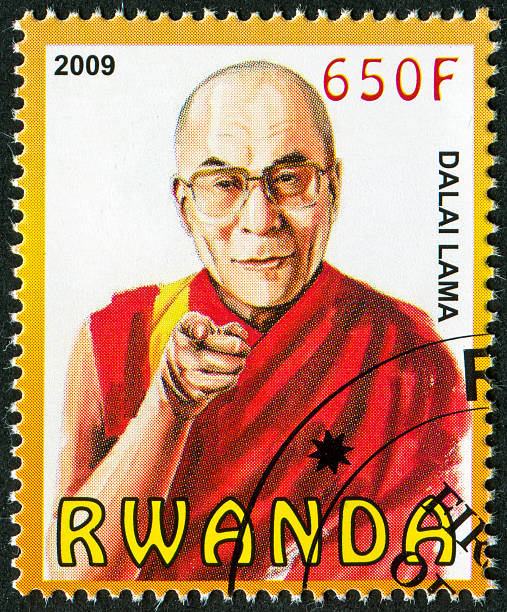 Dalai Lama Stamp "Cancelled Stamp From Rwanda Featuring The Spiritual Leader Of Tibet, The Dalai Lama." dalai lama stock pictures, royalty-free photos & images