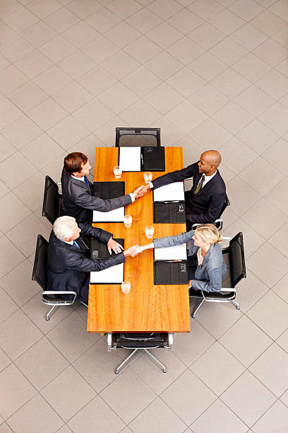 istock Business People Shaking Hands Over a Conference Table 184977182