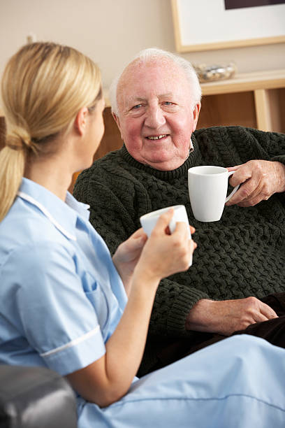 istock Nurse visiting senior man at home 184977665