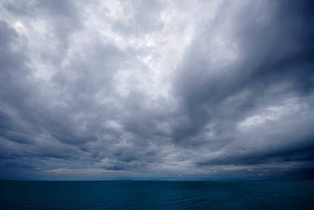 istock Dark, thunderous stormy sky over the ocean at dusk 184977818