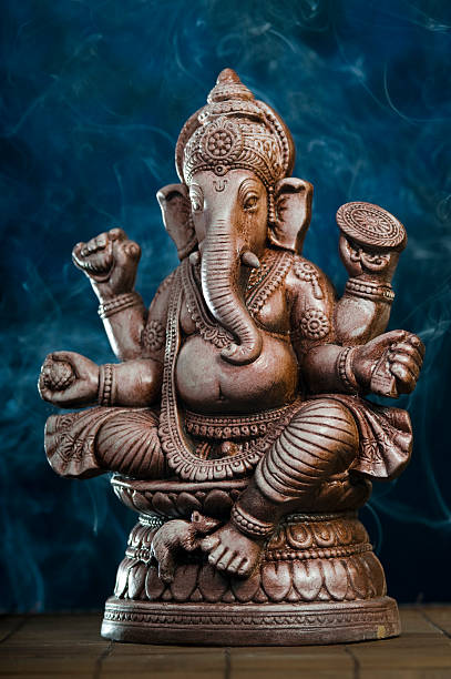 Deity of Ganesha from India on blue background
