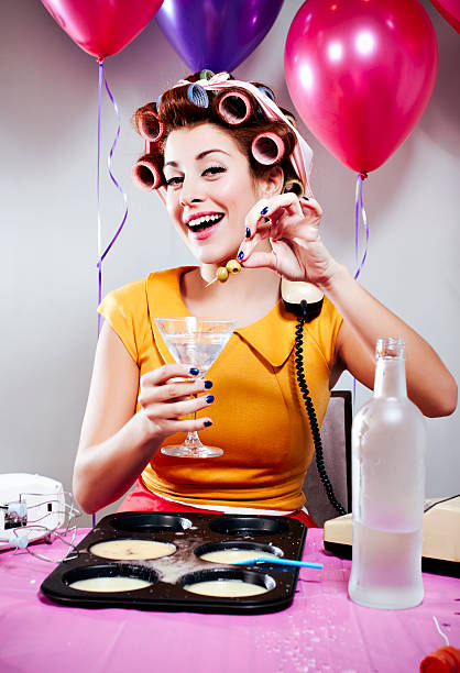 Retro Birthday Shot of a retro woman baking and drinking. retro 1950s kitchen stock pictures, royalty-free photos & images