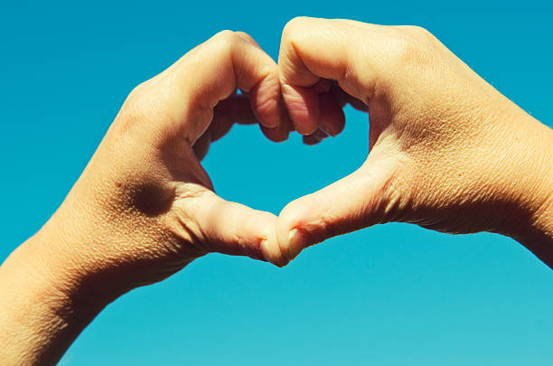 istock St. Valentine hands on blue sky 184978275