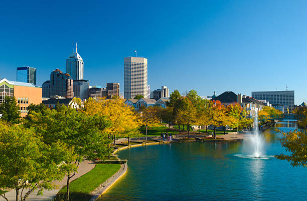 View of Indianapolis skyline and Canal Walk Indianapolis skyline in the distance with houses and the Indiana Central Canal / Canal Walk in the foreground. indianapolis photos stock pictures, royalty-free photos & images