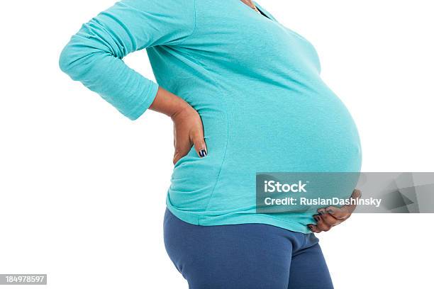 Side Profile View Of A Pregnant Woman Touching Her Belly Stock Photo - Download Image Now