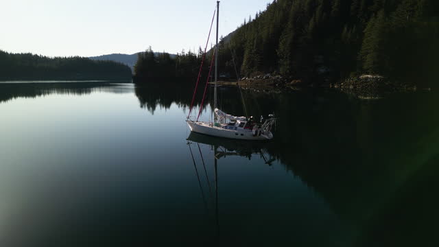 Drone shot of a saillboat moored in still waters of Prince William Sound, Alaska