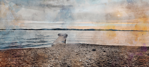 Watercolor effect of a real photo of a pier on a pebble beach at sunset, on Cres Island, Croatia, Europe a blue wavy sea and green island in the background. Watercolor effect on photography.