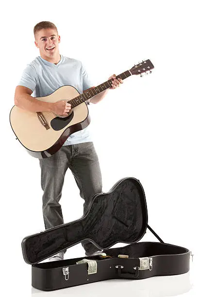 Portrait of happy man playing a guitar
