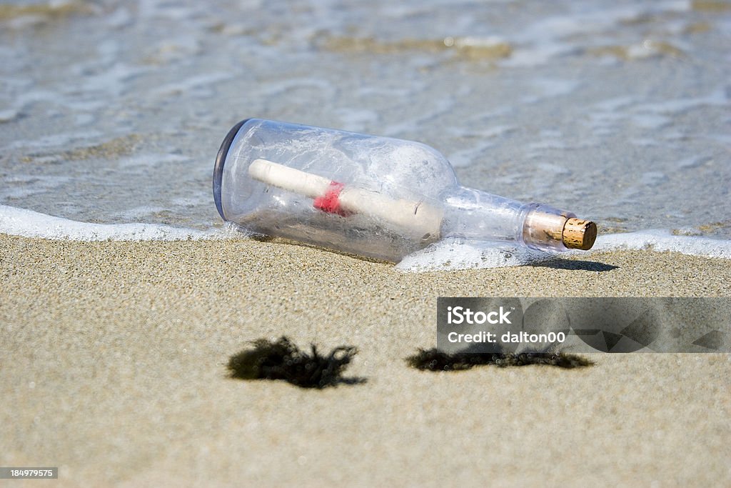Message in a Bottle III A message in a bottle washed up on a beach Beach Stock Photo