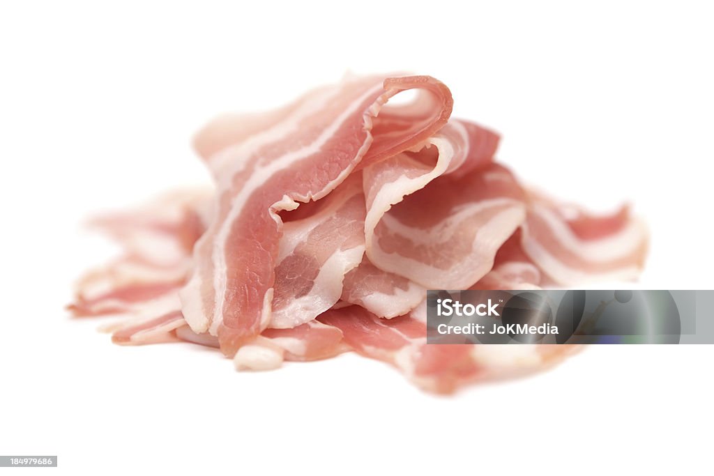 Heap of Raw Bacon Raw bacon slices isolated on a white background. Shallow depth of field. Bacon Stock Photo