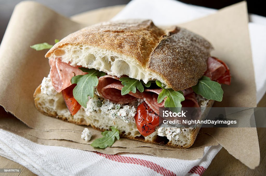 Artisan Salami Sandwich "Rustic sandwich of salami, roasted red peppers, arugula, and herbed goat cheese on ciabatta bread.  Very shallow DOF.MORE IMAGES:" Sandwich Stock Photo