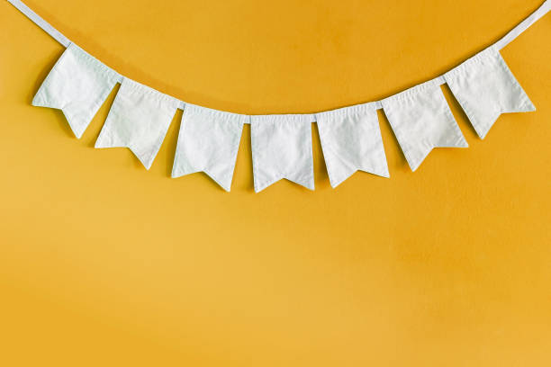 istock White fabric bunting flag on yellow texture background 1849804692