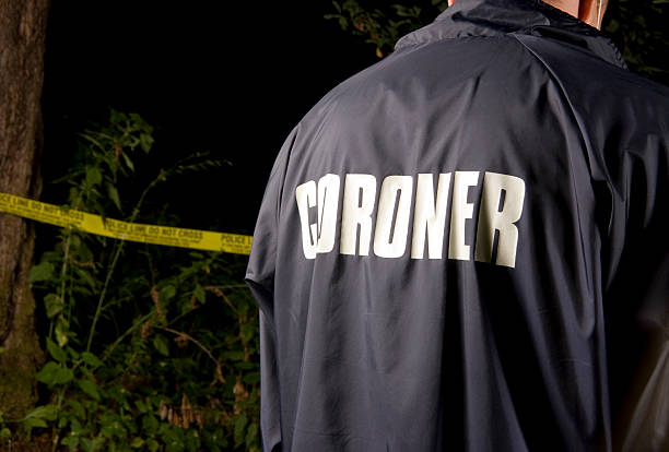 CSI: Coroner "A coroner at a crime scene in the bush / forest. There is police tape blurred in the background.As always, my images are processed from" serial killings photos stock pictures, royalty-free photos & images