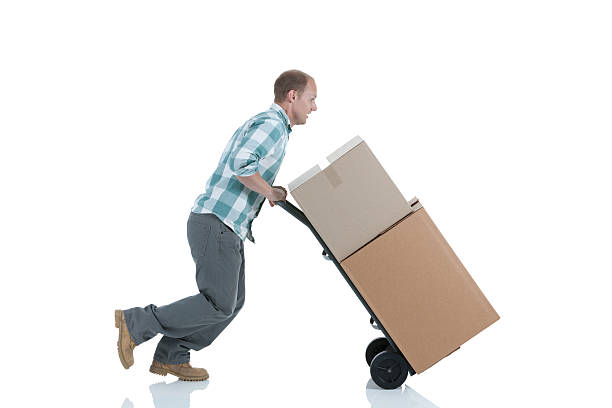 istock Man carrying cardboard boxes in a warehouse 184980623