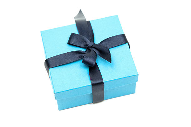 Little blue gift box with a dark ribbon isolated on a white background.