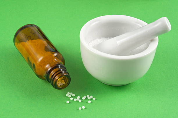 homeopathic medicine close up. globuli (pills) . with medicine mortar