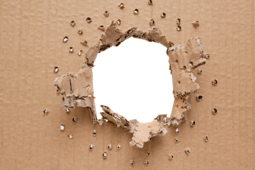 Ripped hole in cardboard background