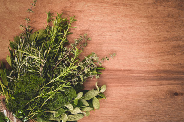 istock Various fresh garden herbs and spices on a wooden background. 1849829576