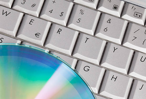 Close-up shoot of keyboard and compact disk