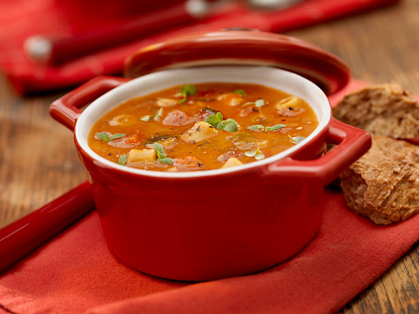 minestrone - tomato soup red basil table stock-fotos und bilder