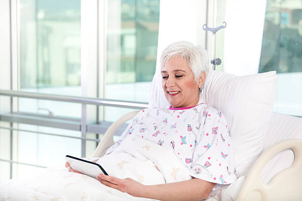 istock white hair patient in bed using tablet at hospital 184984064