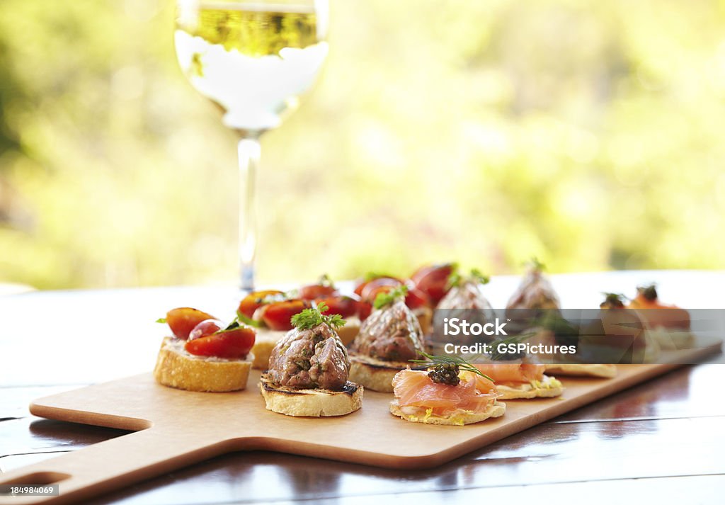 Bruschetta with cheese, tomatoes, foie gras, and wild salmon "Bruschetta with cheese, tomatoes, foie gras, and wild salmon.  Horizontal shot." Appetizer Stock Photo