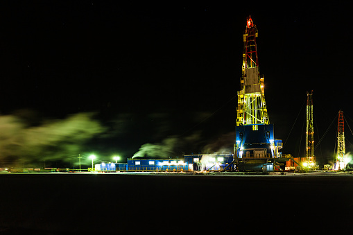 Night photo drilling rig in oil field for drilled into subsurface