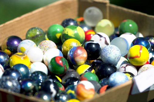 collection of antique marbles in a box