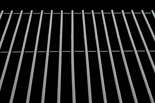 Oven rack/Grilling rack Black oven rack over pure black background. Can be used for placing baked dishes on(as if in the oven)or cooling.Additional black can be added vertically for copy space. could also be used to depict grilling. metal grate photos stock pictures, royalty-free photos & images