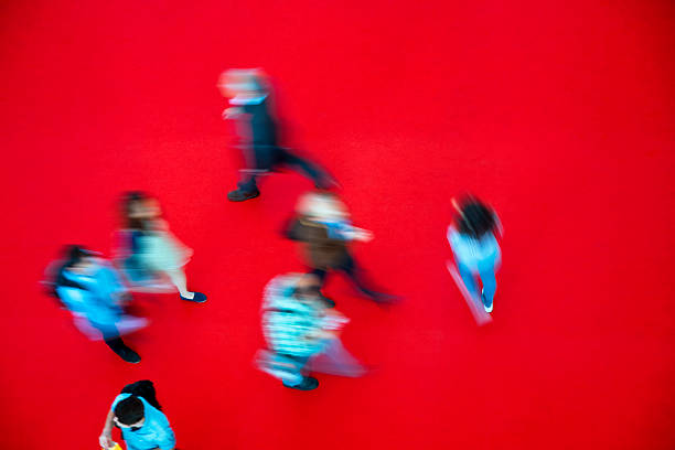 istock Crowd of Blurred People Walking Fast on Red Carpet 184984561