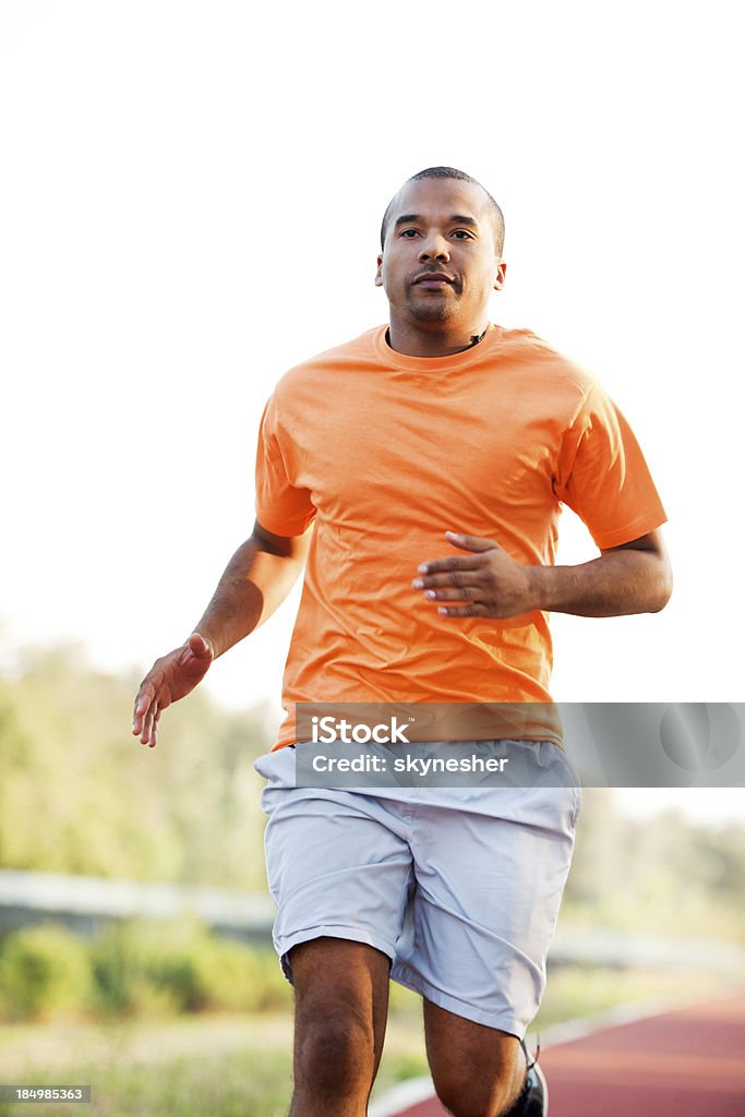 African-American man running at the marathon. Young male marathon runner. Running Stock Photo