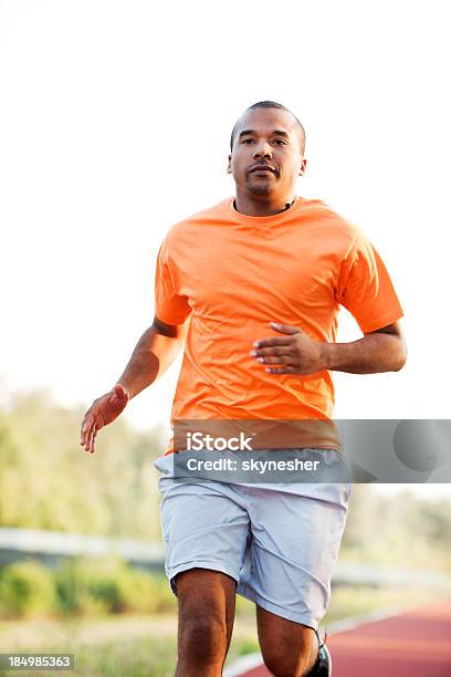 Africanamerican Man Running At The Marathon Stock Photo - Download Image Now - Running, 10000 Meter, Track Event