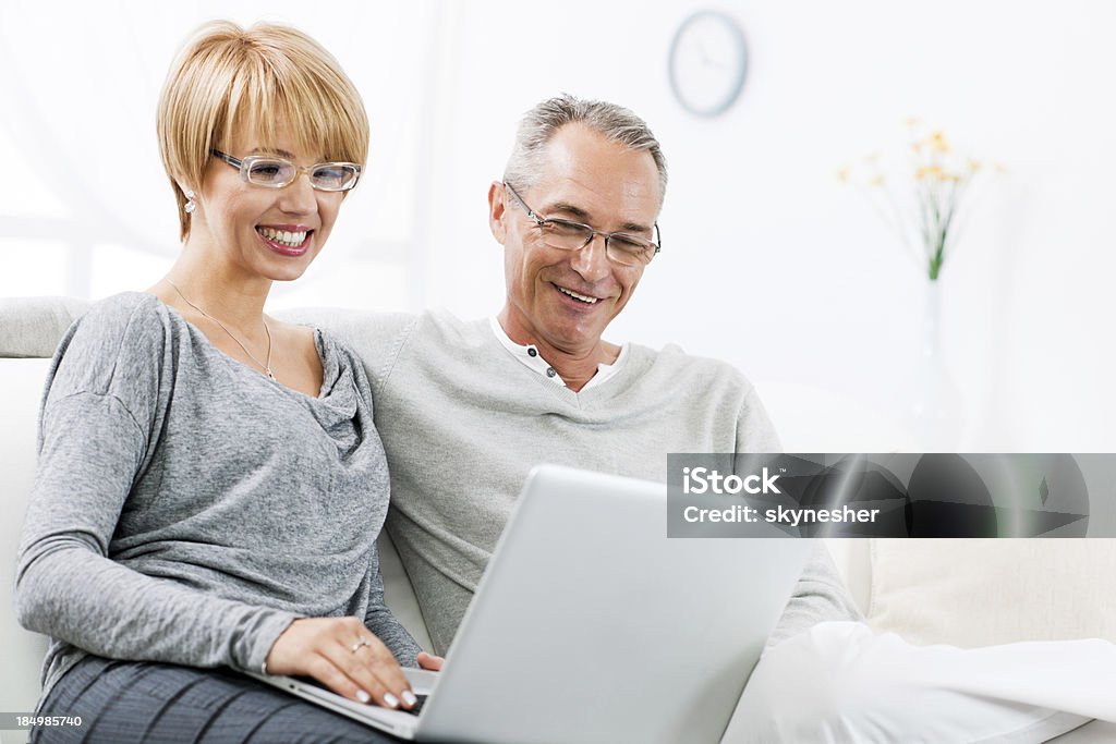 couple heureux à l'aide d'un ordinateur portable ensemble à la maison - Photo de Adulte libre de droits