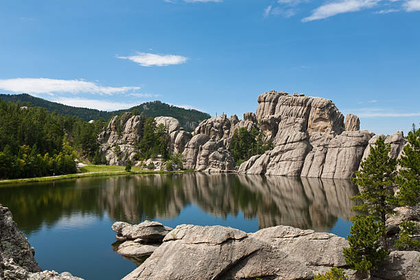 Black Hills landscape with a lake; South Dakota "Black Hills landscape- a beautiful Sylvan Lake with granite hills and pine trees surrounding it on a sunny, summer day; South Dakota" south dakota stock pictures, royalty-free photos & images